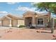 Inviting single-story home with desert landscaping, three-car garage, and covered entryway at 6781 W Lone Cactus Dr, Glendale, AZ 85308