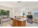 Open concept kitchen featuring an island bar and blending seamlessly with a cozy living space at 6781 W Lone Cactus Dr, Glendale, AZ 85308