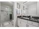 Modern bathroom with a glass-enclosed shower, marble tile, and vanity with granite top at 7575 E Indian Bend Rd # 1142, Scottsdale, AZ 85250