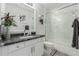 Stylish bathroom featuring a granite countertop, and a glass-enclosed shower-tub combination at 7575 E Indian Bend Rd # 1142, Scottsdale, AZ 85250