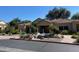 Sienna Condominiums clubhouse with a decorative water feature and lush landscaping at 7575 E Indian Bend Rd # 1142, Scottsdale, AZ 85250