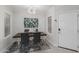 Modern dining room with stylish chairs, a decorative light fixture, and large windows at 7575 E Indian Bend Rd # 1142, Scottsdale, AZ 85250