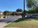 Sienna Condominiums entrance with a well-maintained road and desert landscaping at 7575 E Indian Bend Rd # 1142, Scottsdale, AZ 85250