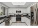 Well-lit kitchen with white cabinets, stainless steel appliances, and dark countertops at 7575 E Indian Bend Rd # 1142, Scottsdale, AZ 85250