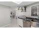Bright kitchen featuring a stainless steel farmhouse sink, granite counters, and stylish decor at 7575 E Indian Bend Rd # 1142, Scottsdale, AZ 85250