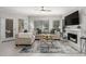 Cozy living room featuring stylish sofas, a fireplace, and large windows for natural light at 7575 E Indian Bend Rd # 1142, Scottsdale, AZ 85250