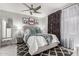Comfortable bedroom with a ceiling fan, patterned rug, and stylish window treatments at 7575 E Indian Bend Rd # 1142, Scottsdale, AZ 85250
