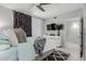 Bedroom with decorative curtains, a ceiling fan, and a TV over a modern dresser at 7575 E Indian Bend Rd # 1142, Scottsdale, AZ 85250