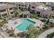 Aerial view of community pool and spa with lush landscaping and shaded seating areas at 7575 E Indian Bend Rd # 1142, Scottsdale, AZ 85250