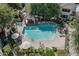 Aerial view of a sparkling pool and spa area with a gazebo in a lushly landscaped community at 7575 E Indian Bend Rd # 1142, Scottsdale, AZ 85250