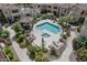 Aerial view of a pristine pool and spa area with lush landscaping and a gazebo in the community at 7575 E Indian Bend Rd # 1142, Scottsdale, AZ 85250