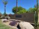 Sienna Condominiums sign with desert landscaping, including cactus and flowering bushes at 7575 E Indian Bend Rd # 1142, Scottsdale, AZ 85250
