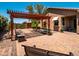 Spacious backyard with paved patio, covered pergola, and stylish outdoor seating at 7648 S Thimble Peak --, Gold Canyon, AZ 85118