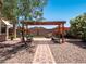 Inviting backyard with pergola, seating, and meticulously laid brick pathway at 7648 S Thimble Peak --, Gold Canyon, AZ 85118
