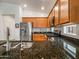 Bright kitchen featuring stainless steel appliances, sink, and dark granite counters at 7648 S Thimble Peak --, Gold Canyon, AZ 85118