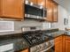 Modern kitchen featuring a stainless steel gas range, oven, and granite countertops at 7648 S Thimble Peak --, Gold Canyon, AZ 85118