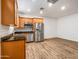 Open kitchen with stainless steel appliances, wood cabinets, granite counters, and modern flooring at 7648 S Thimble Peak --, Gold Canyon, AZ 85118