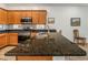 Well-designed kitchen with an island, dark granite countertops, and wooden cabinets at 7648 S Thimble Peak --, Gold Canyon, AZ 85118