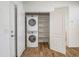 Efficient laundry closet with stacked washer/dryer unit and shelving for optimal storage at 7648 S Thimble Peak --, Gold Canyon, AZ 85118