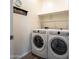 Bright laundry room featuring a front-loading washer and dryer, and plenty of storage shelves at 7648 S Thimble Peak --, Gold Canyon, AZ 85118