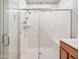 Modern walk-in shower featuring glass doors, adjustable shower head, and a built-in bench for added comfort at 7648 S Thimble Peak --, Gold Canyon, AZ 85118