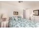 Comfortable bedroom with a patterned bedspread, side tables with lamps, and white dressers for storage at 8103 E Southern Ave # 75, Mesa, AZ 85209