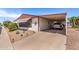 This home includes a convenient carport, desert landscaping, and a peek of palm trees at 8103 E Southern Ave # 75, Mesa, AZ 85209