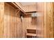 A compact closet features wood paneling, hanging racks, and a storage shelf for efficiently organized storage solutions at 8103 E Southern Ave # 75, Mesa, AZ 85209
