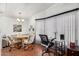Dining area with a wooden table, four rolling chairs, and a desk and chair for at-home office work at 8103 E Southern Ave # 75, Mesa, AZ 85209