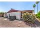 Home's exterior complemented by a flowering bush and palm trees, enhanced by a well-maintained gravel yard at 8103 E Southern Ave # 75, Mesa, AZ 85209