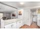 Galley kitchen with a view of dining and living areas and appliances including a washer and dryer at 8103 E Southern Ave # 75, Mesa, AZ 85209