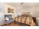 Main bedroom with a wooden floor and an ornate chair near a window with decorative curtains at 8103 E Southern Ave # 75, Mesa, AZ 85209