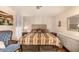 Well-lit main bedroom with a wooden floor and a headboard with an upholstered bed at 8103 E Southern Ave # 75, Mesa, AZ 85209