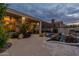 Expansive backyard featuring a covered patio, well-manicured landscaping, a pool, and cozy outdoor seating for entertaining at 9678 E Voltaire Dr, Scottsdale, AZ 85260
