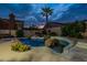 Inviting pool and spa with rock accents and lush landscaping for ultimate backyard relaxation at 9678 E Voltaire Dr, Scottsdale, AZ 85260