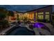 Backyard with a pool, spa, rock features, and ample entertaining space at 9678 E Voltaire Dr, Scottsdale, AZ 85260