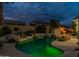 Beautiful pool with rock features and lush landscaping, perfect for outdoor enjoyment at 9678 E Voltaire Dr, Scottsdale, AZ 85260