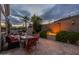 Cozy backyard patio with fire feature, outdoor seating, lush greenery, and privacy wall perfect for evening gatherings at 9678 E Voltaire Dr, Scottsdale, AZ 85260