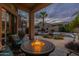 Inviting backyard patio featuring a fire pit and comfortable seating area, perfect for outdoor relaxation and entertainment at 9678 E Voltaire Dr, Scottsdale, AZ 85260