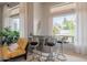 Stylish bar area featuring modern seating, unique decor, and a view of the outside greenery at 9678 E Voltaire Dr, Scottsdale, AZ 85260