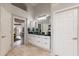 Bright bathroom with a marble countertop, tile floors, and doorway to the bedroom at 9678 E Voltaire Dr, Scottsdale, AZ 85260