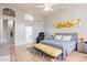 Bedroom with hardwood floors, a view of an ensuite bathroom, and a painting on the wall at 9678 E Voltaire Dr, Scottsdale, AZ 85260