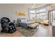 Bedroom with hardwood floors, yellow chairs by the windows, and a painting above the bed at 9678 E Voltaire Dr, Scottsdale, AZ 85260