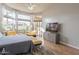 Bright bedroom with large windows, hardwood floors, and yellow couches for relaxation at 9678 E Voltaire Dr, Scottsdale, AZ 85260
