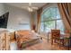 Cozy bedroom with a ceiling fan, a large window, and a wooden desk at 9678 E Voltaire Dr, Scottsdale, AZ 85260