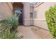 Home entryway featuring desert landscaping and a dark front door with sidelight window at 9678 E Voltaire Dr, Scottsdale, AZ 85260