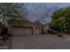 Charming home exterior boasting stucco walls, tile roof, mature trees, and a three-car garage at 9678 E Voltaire Dr, Scottsdale, AZ 85260
