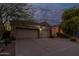 Charming home featuring a three-car garage and desert landscaping at 9678 E Voltaire Dr, Scottsdale, AZ 85260