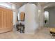 Home foyer featuring tile flooring, a front door, and an ornate console table at 9678 E Voltaire Dr, Scottsdale, AZ 85260