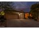 Well-maintained home exterior featuring a large three-car garage with new doors and fresh desert landscaping at 9678 E Voltaire Dr, Scottsdale, AZ 85260
